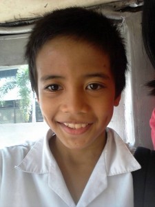 A bedimpled smile from a child during a jeepney ride.