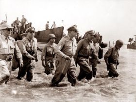 United States GI's led by General Douglas MacArthur in their first promised return in 1944