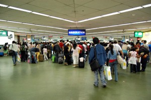 Arriving passengers lining up at the passport control counters at the Ninoy Aquino International Airport Terminal 1