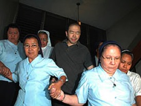 Striking a heroic stance: Jun Lozada surrounded by attack nuns