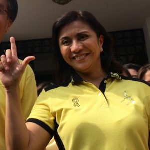VP candidate Leni Robredo flashes the 'Laban' sign while wearing a Yellow shirt.